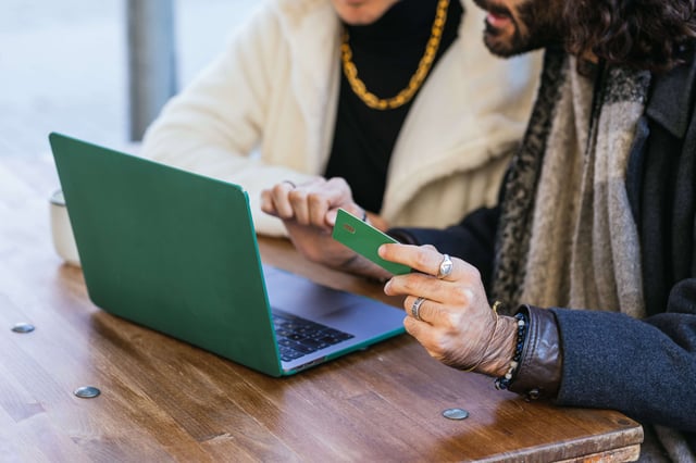 gay-couple-shopping-online-using-laptop-and-credit-2025-01-10-03-19-23-utc-min